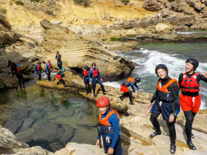 a group of people on a rocky beach
