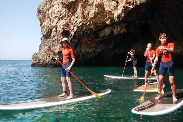 a man riding on the back of a boat in the water