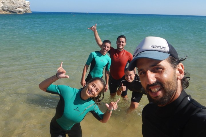 a man standing next to a body of water