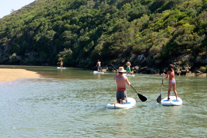 a person standing next to a body of water