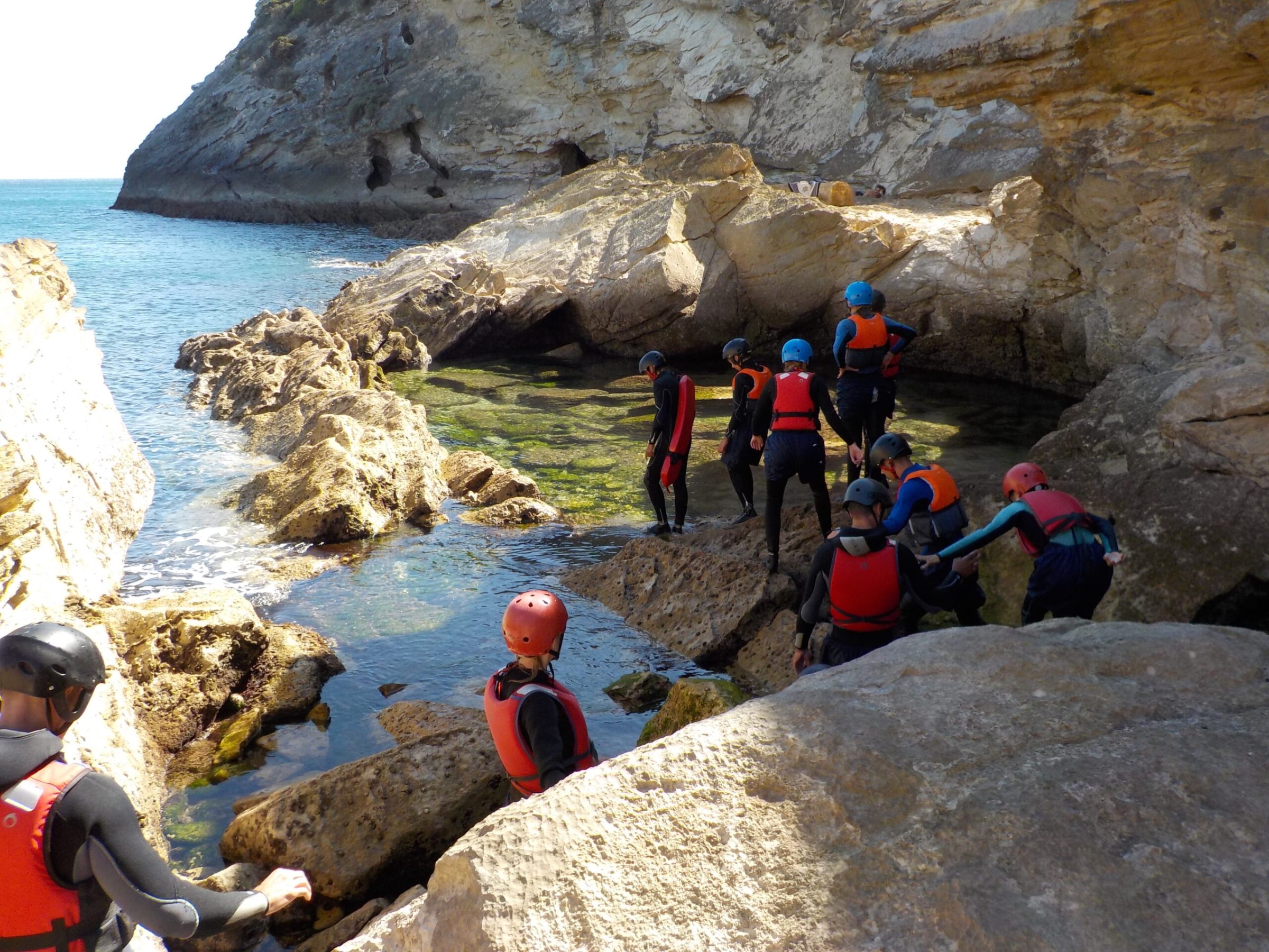 a group of people sitting on a rock