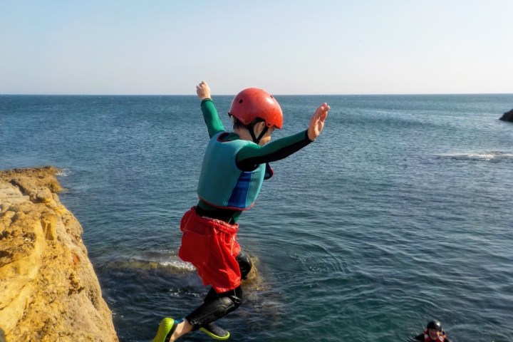 a person standing next to a body of water