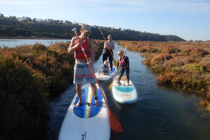 a person riding on the back of a boat in a body of water