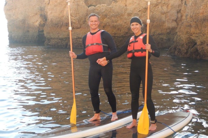 a person standing next to a body of water